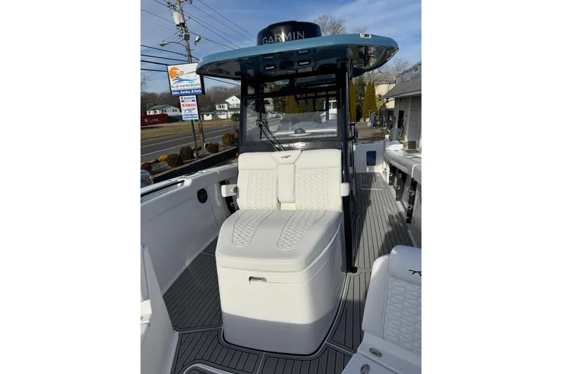 Slide: The Image of 2026 Tidewater 302 CC Adventure boat interior with cushioned seating and modern design. - 28