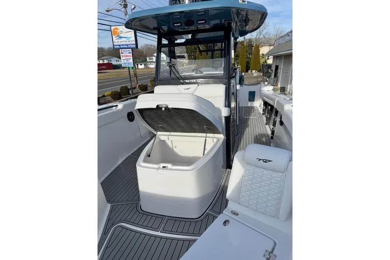 Slide: The Image of 2026 Tidewater 302 CC Adventure boat interior with open storage compartment. - 30
