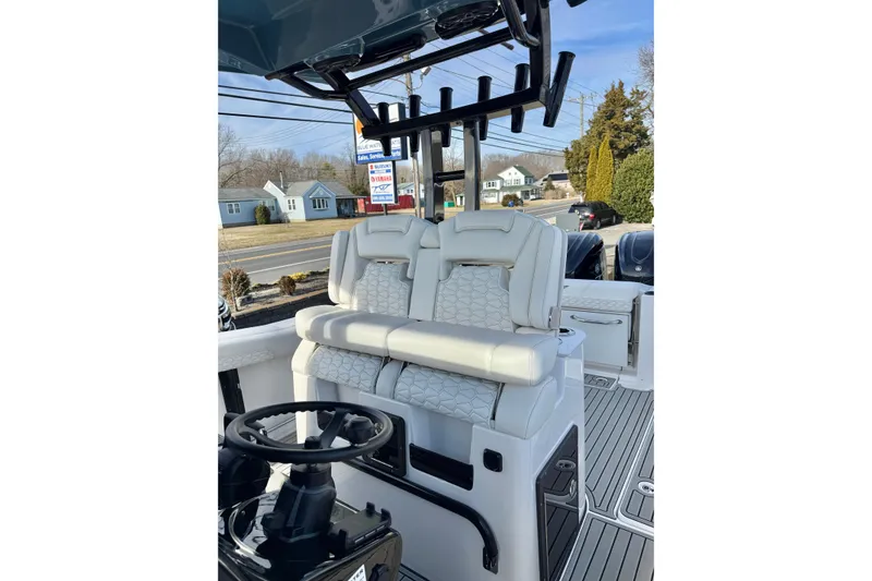 Slide: The Image of 2026 Tidewater 302 CC Adventure boat interior with dual seats and steering wheel. - 33