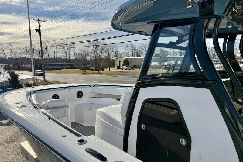 Slide: The Image of 2026 Tidewater 302 CC Adventure boat, sleek design, spacious deck, modern features, outdoor setting. - 37