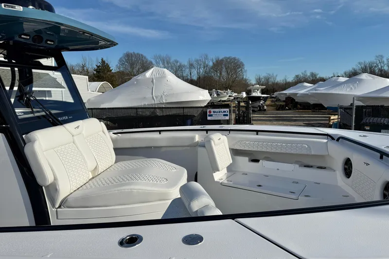 Slide: The Image of 2026 Tidewater 302 CC Adventure boat with white seating and outdoor storage area. - 39