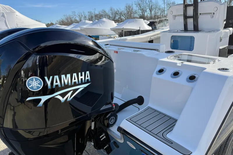 Slide: The Image of 2026 Tidewater 302 CC Adventure boat with Yamaha outboard engine, docked outdoors. - 9