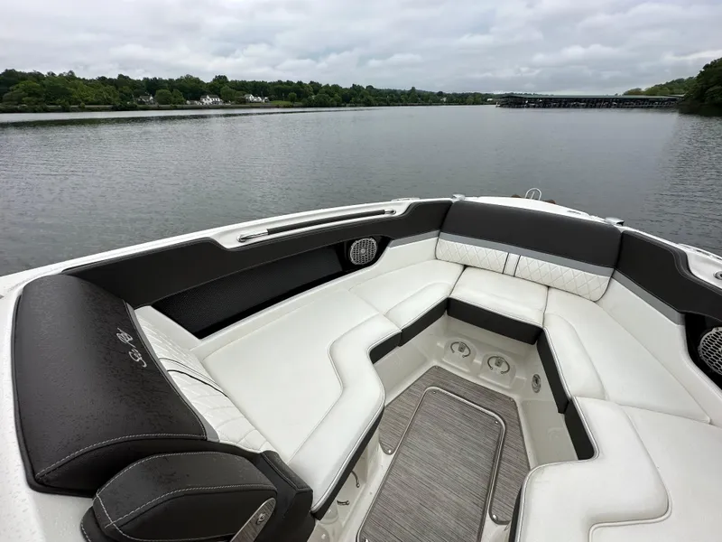 Slide: The Image of 2017 Sea Ray SLX 280 boat interior with luxurious seating on a calm lake. - 10
