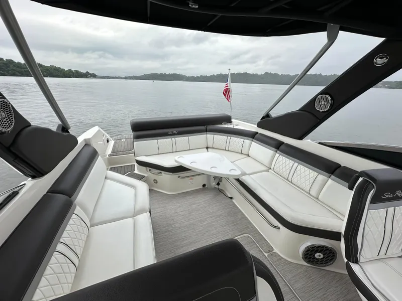 Slide: The Image of Luxurious 2017 Sea Ray SLX 280 boat interior with spacious seating on a calm lake. - 15
