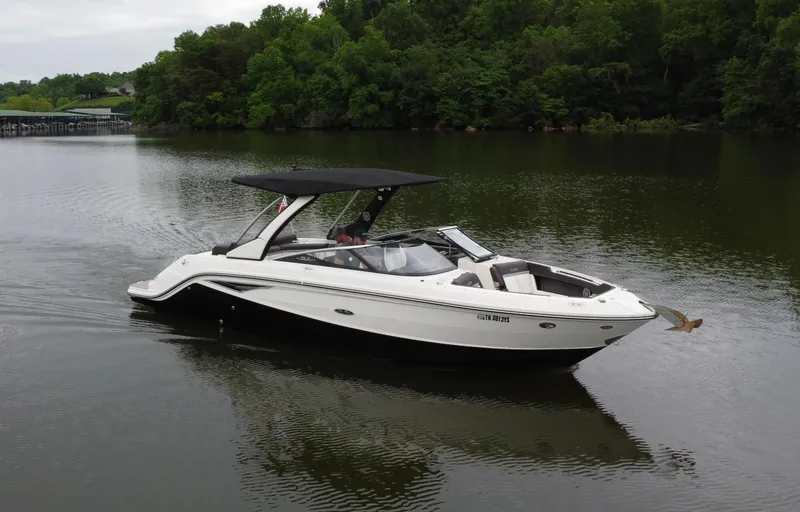 Slide: The Image of 2017 Sea Ray SLX 280 boat on calm lake with lush green trees. - 8