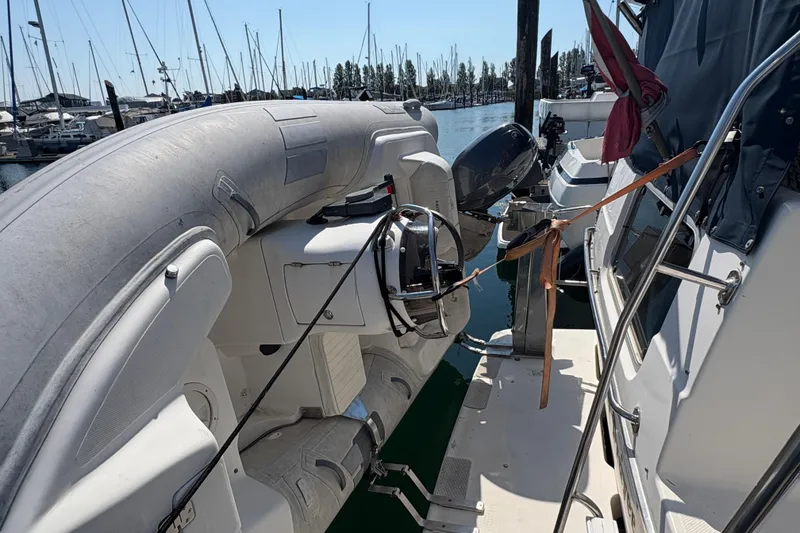 Slide: The Image of 1988 Bayliner 3587 Motoryacht docked with inflatable dinghy and outboard motor. - 10