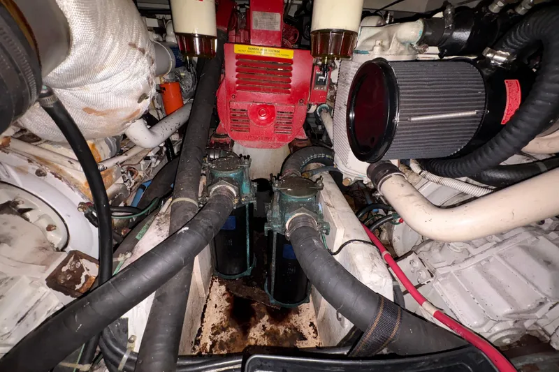 Slide: The Image of Engine room of a 1988 Bayliner 3587 Motoryacht with visible components and hoses. - 103