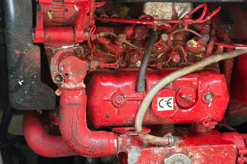 Slide: The Image of Red engine of a 1988 Bayliner 3587 Motoryacht, showing hoses and components. - 105