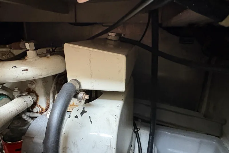 Slide: The Image of Engine compartment of 1988 Bayliner 3587 Motoryacht showing mechanical components and hoses. - 108