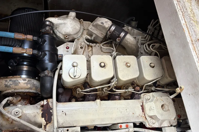 Slide: The Image of Engine compartment of a 1988 Bayliner 3587 Motoryacht, showing mechanical components and connections. - 111