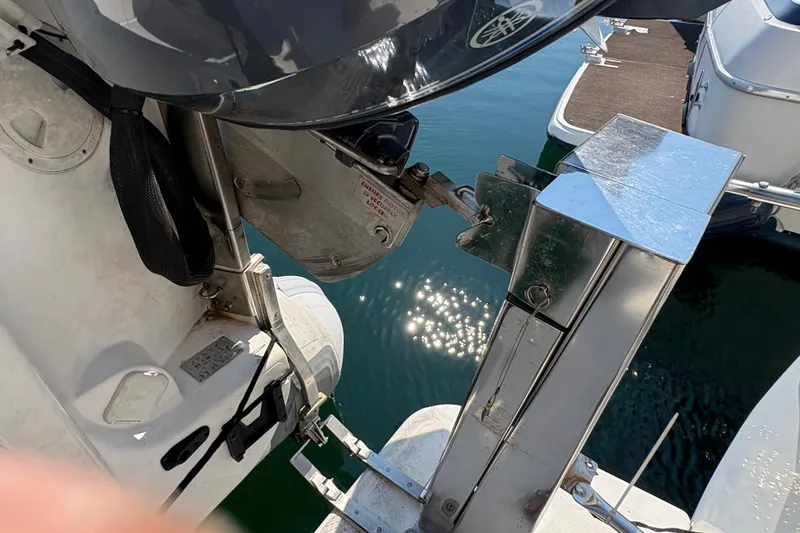 Slide: The Image of 1988 Bayliner 3587 Motoryacht with outboard motor and dock reflection on water. - 15