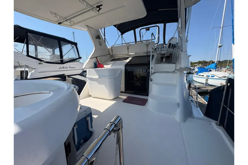 Slide: The Image of 1988 Bayliner 3587 Motoryacht interior with seating, steps, and marina view. - 19