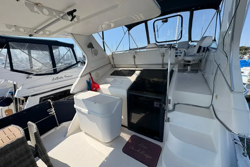 Slide: The Image of 1988 Bayliner 3587 Motoryacht interior with seating, steps, and marina view. - 26