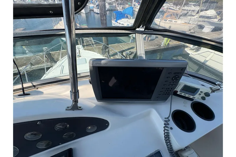 Slide: The Image of 1988 Bayliner 3587 Motoryacht helm with GPS and marina view. - 32
