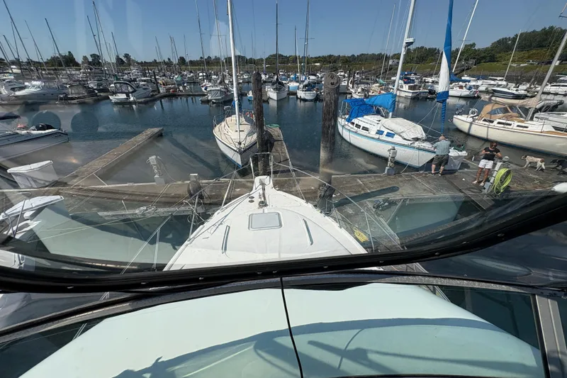 Slide: The Image of 1988 Bayliner 3587 Motoryacht docked in a busy marina with sailboats. - 36