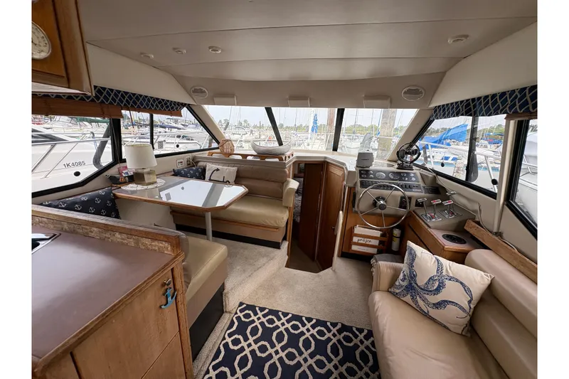 Slide: The Image of Interior of 1988 Bayliner 3587 Motoryacht, featuring helm, seating, and nautical decor. - 45