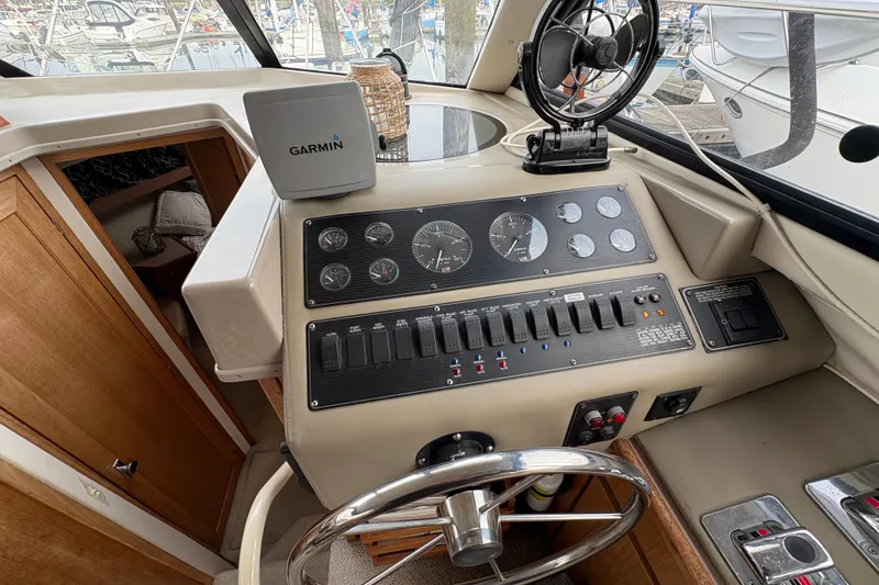 Slide: The Image of 1988 Bayliner 3587 Motoryacht helm with Garmin navigation, gauges, and controls. - 53