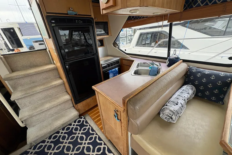 Slide: The Image of Interior of 1988 Bayliner 3587 Motoryacht with kitchen and seating area. - 57