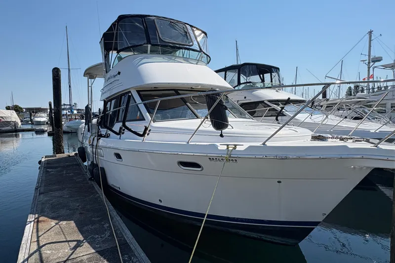 Slide: The Image of 1988 Bayliner 3587 Motoryacht docked at marina, clear sky, calm water. - 6