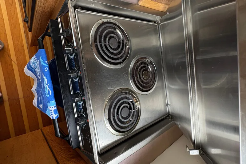 Slide: The Image of Stovetop in 1988 Bayliner 3587 Motoryacht kitchen with blue towel. - 61