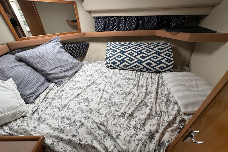 Slide: The Image of Cozy bedroom in 1988 Bayliner 3587 Motoryacht with patterned bedding and pillows. - 77