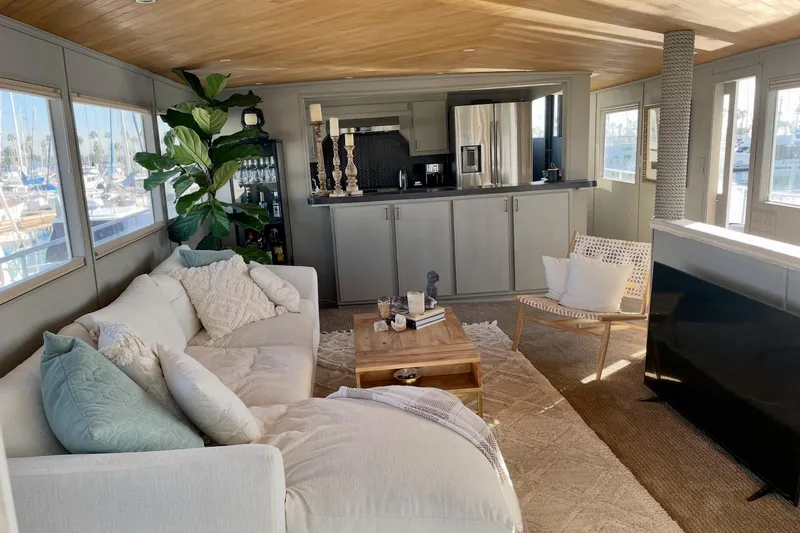 Slide: The Image of Luxurious interior of a 1977 Huckins Motor Yacht with cozy seating and modern kitchen. - 10