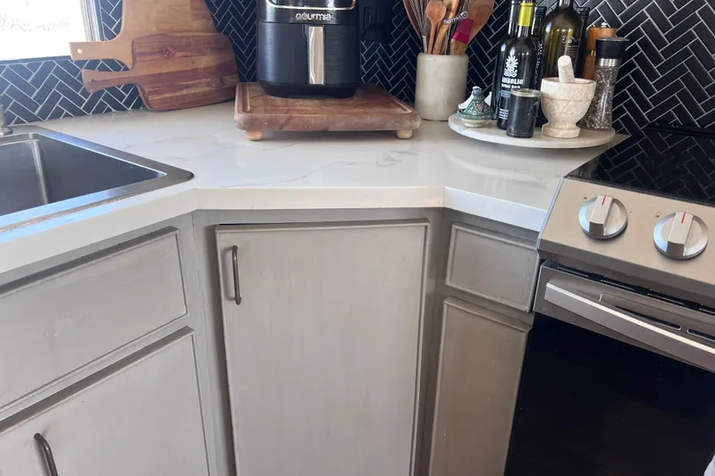 Slide: The Image of Modern kitchen corner with appliances, cutting boards, and utensils on a Huckins 1977 Motor Yacht. - 17