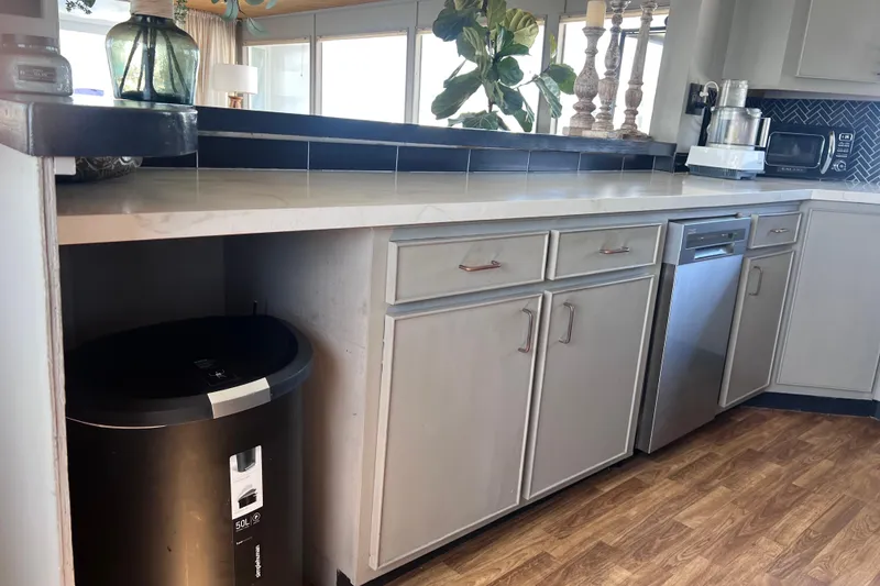 Slide: The Image of 1977 Huckins Motor Yacht kitchen with modern appliances and wood flooring. - 19