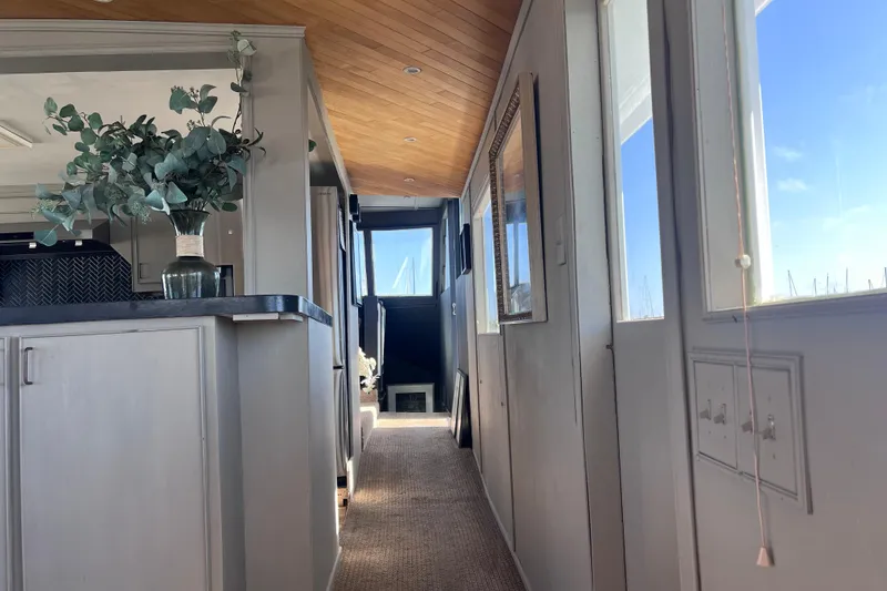 Slide: The Image of Interior of a 1977 Huckins Motor Yacht with elegant decor and natural light. - 20