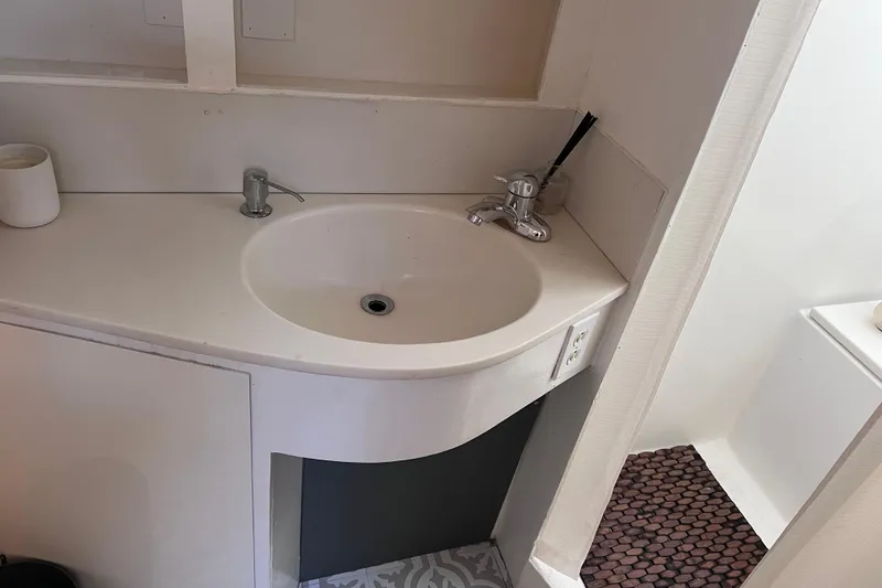 Slide: The Image of 1977 Huckins Motor Yacht bathroom sink with modern faucet and minimalist design. - 30