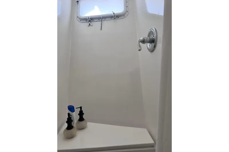 Slide: The Image of Shower area in 1977 Huckins Motor Yacht with window and soap dispensers. - 32