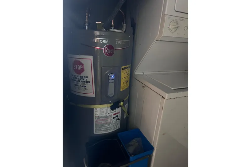 Slide: The Image of Water heater and laundry unit on 1977 Huckins Motor Yacht. - 36