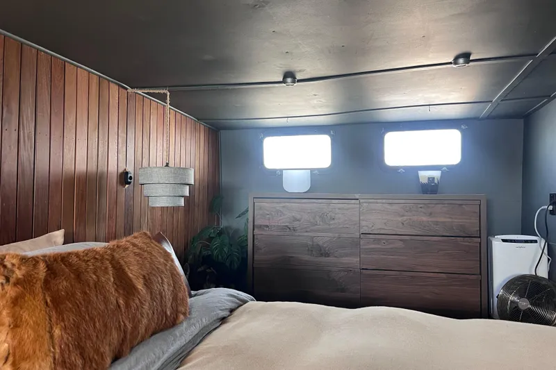 Slide: The Image of Cozy 1977 Huckins Motor Yacht bedroom with wood paneling and modern decor. - 42