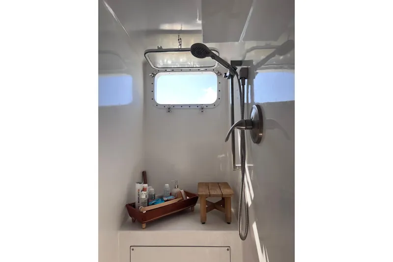 Slide: The Image of Shower area in 1977 Huckins Motor Yacht with window and toiletries. - 46