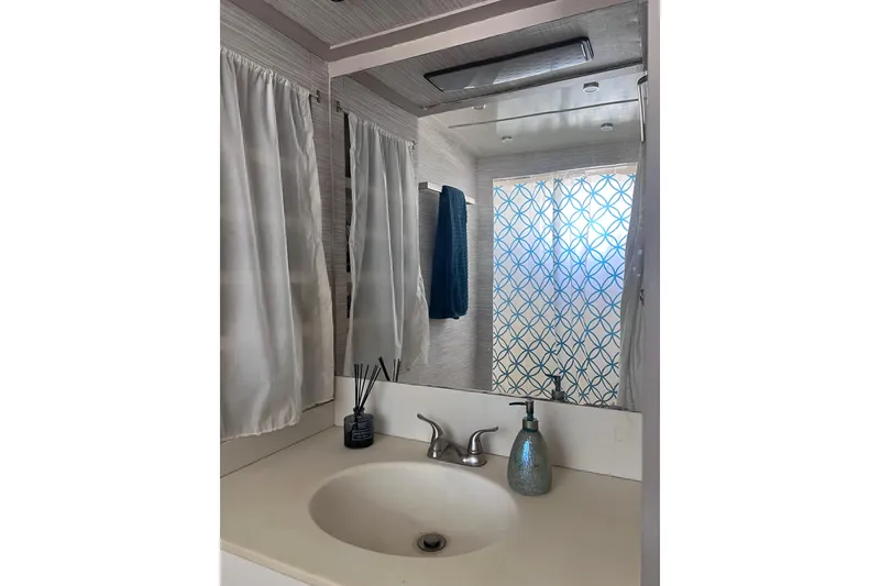Slide: The Image of Bathroom interior of 1977 Huckins Motor Yacht with sink, mirror, and decorative elements. - 51