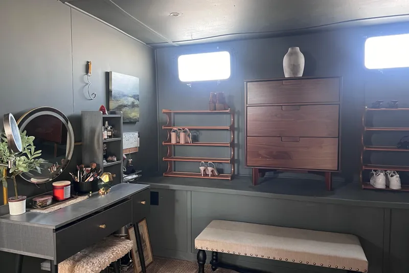 Slide: The Image of Interior of a 1977 Huckins Motor Yacht with vanity, dresser, and shoe racks. - 55