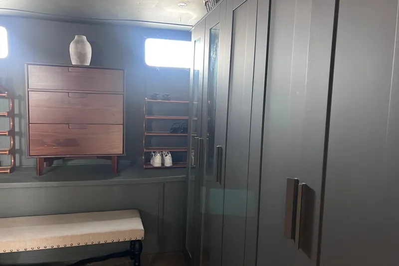 Slide: The Image of Interior of 1977 Huckins Motor Yacht with modern cabinetry and storage solutions. - 56