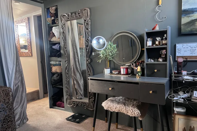 Slide: The Image of Cozy vanity area on 1977 Huckins Motor Yacht with mirror, shelves, and decor. - 57