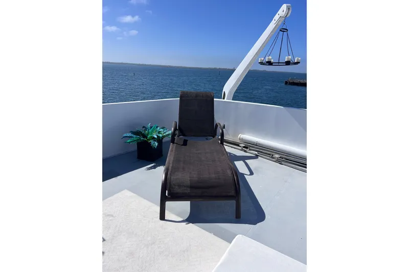 Slide: The Image of 1977 Huckins Motor Yacht deck with lounge chair and ocean view. - 60