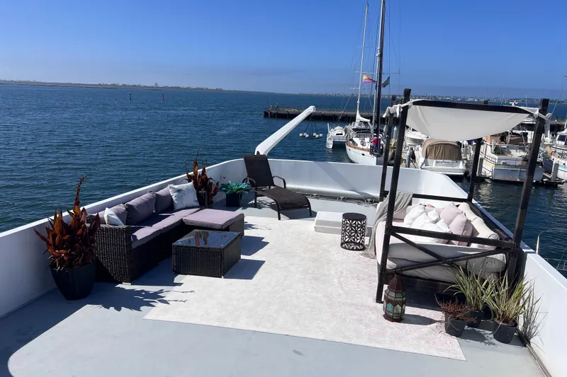 Slide: The Image of Luxurious 1977 Huckins Motor Yacht deck with elegant seating and ocean view. - 62