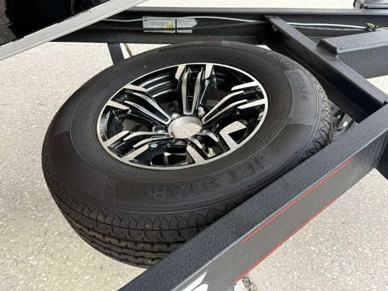 Slide: The Image of Spare tire on a 2022 Caymas CX 19 boat trailer. - 18