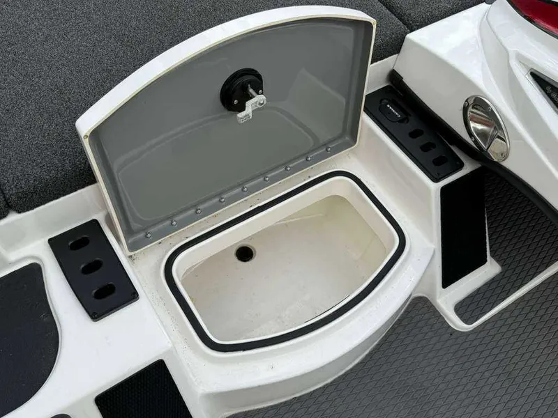 Slide: The Image of Open storage compartment on a 2022 Caymas CX 19 boat. - 21