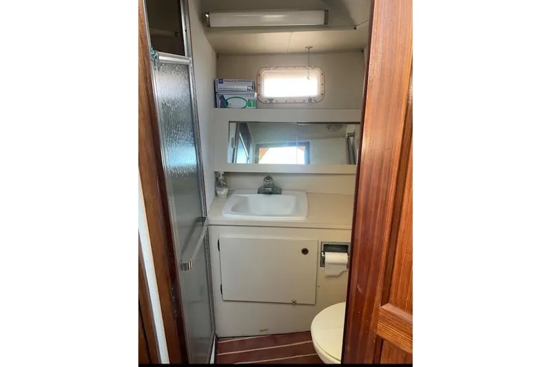Slide: The Image of Bathroom interior of 1985 Hatteras 36 Convertible yacht, featuring sink and mirror. - 7