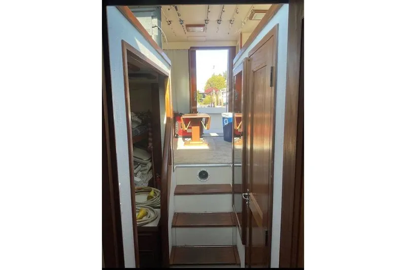 Slide: The Image of Interior view of 1985 Hatteras 36 Convertible boat with wooden stairs and storage. - 8