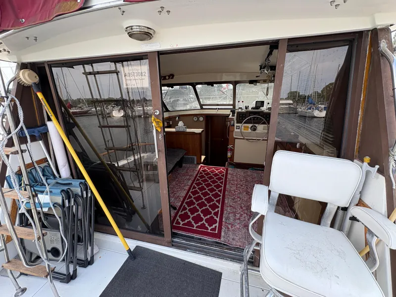 Slide: The Image of 1986 Trojan 32 Sedan boat interior with helm, seating, and nautical equipment. - 22
