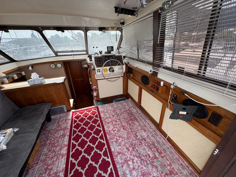 Slide: The Image of 1986 Trojan 32 Sedan interior with steering wheel, red carpet, and wooden accents. - 23