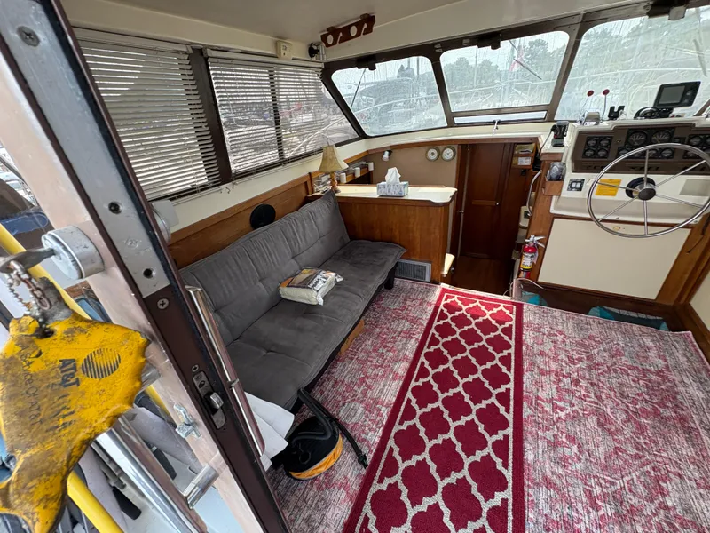 Slide: The Image of Interior of a 1986 Trojan 32 Sedan boat with cozy seating and nautical decor. - 25