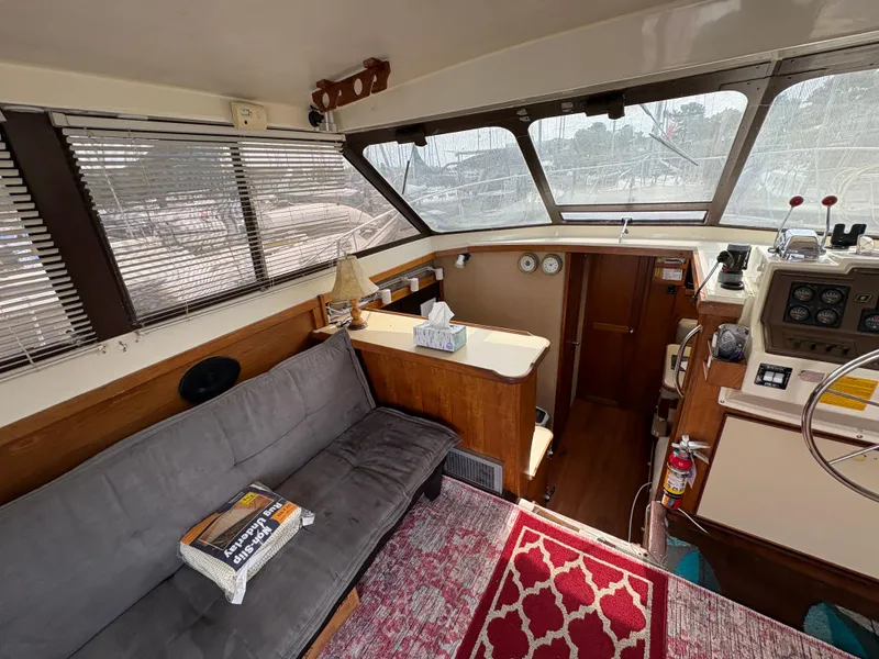 Slide: The Image of Interior of 1986 Trojan 32 Sedan boat with helm, seating, and nautical decor. - 26