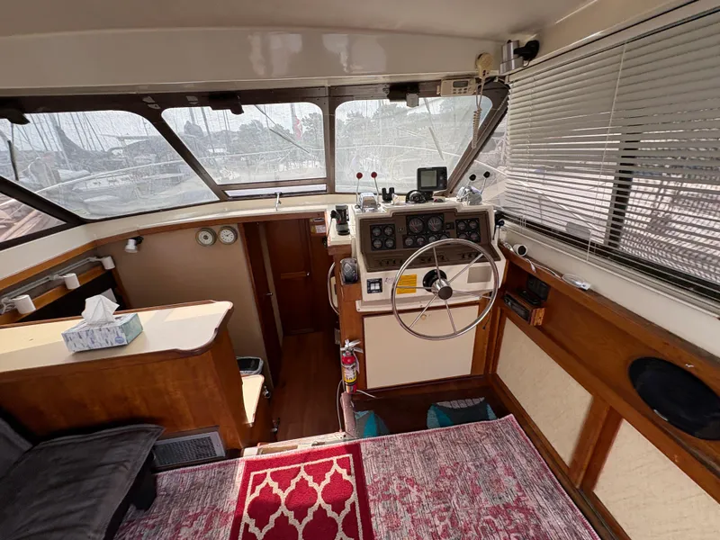 Slide: The Image of Interior of a 1986 Trojan 32 Sedan boat with steering wheel and navigation instruments. - 27