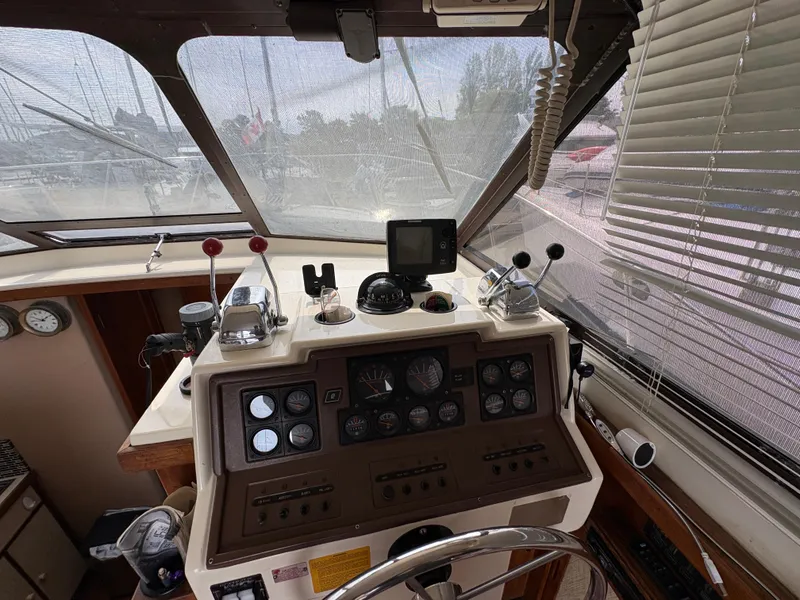 Slide: The Image of 1986 Trojan 32 Sedan boat cockpit with navigation instruments and steering wheel. - 29
